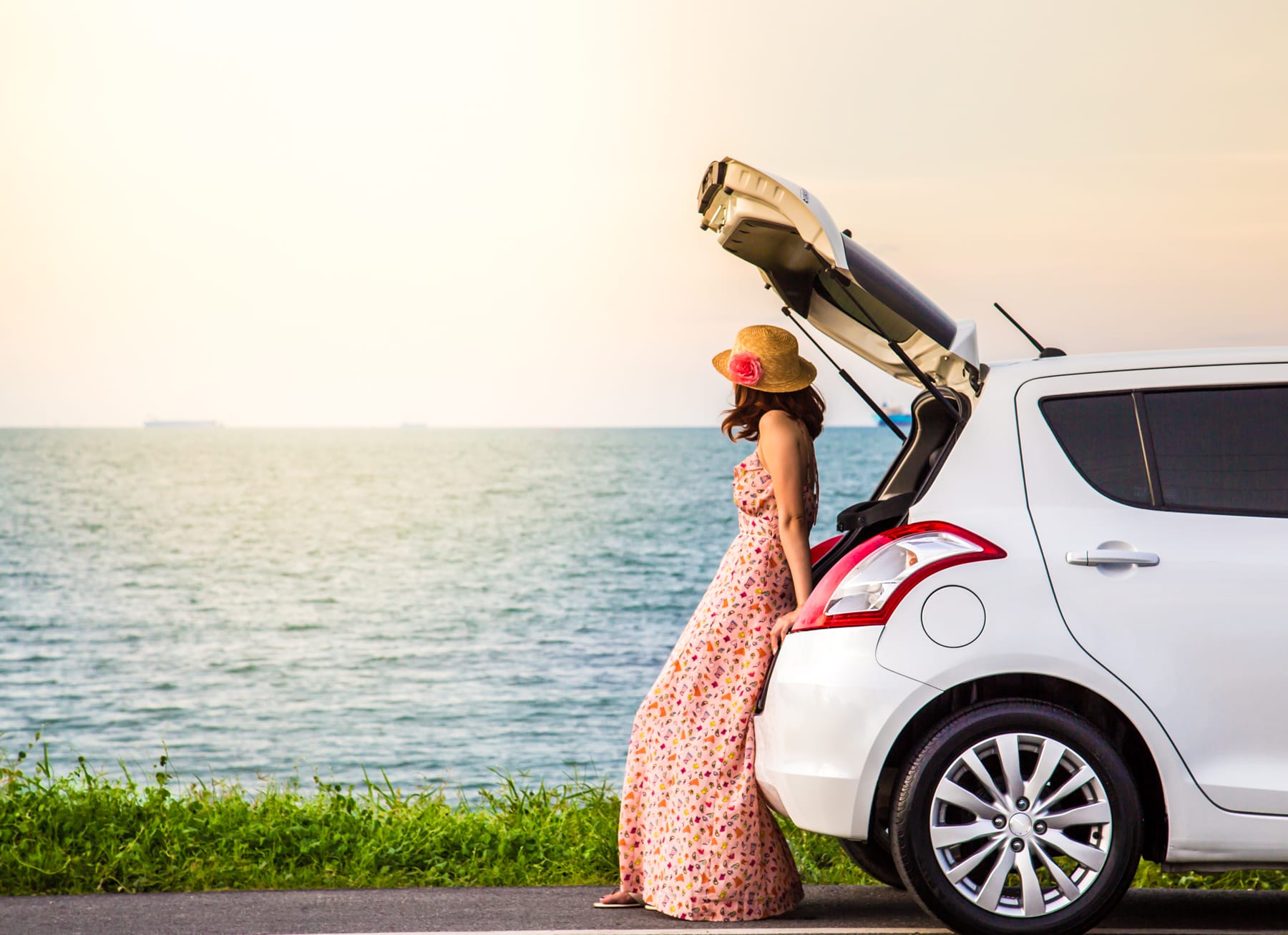 Automax Corfu Car Rental girl siting on a car